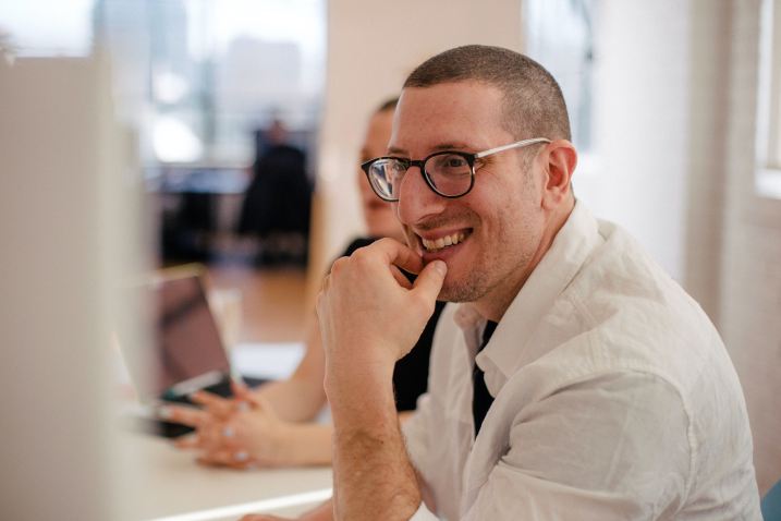 A smiling man at his desk